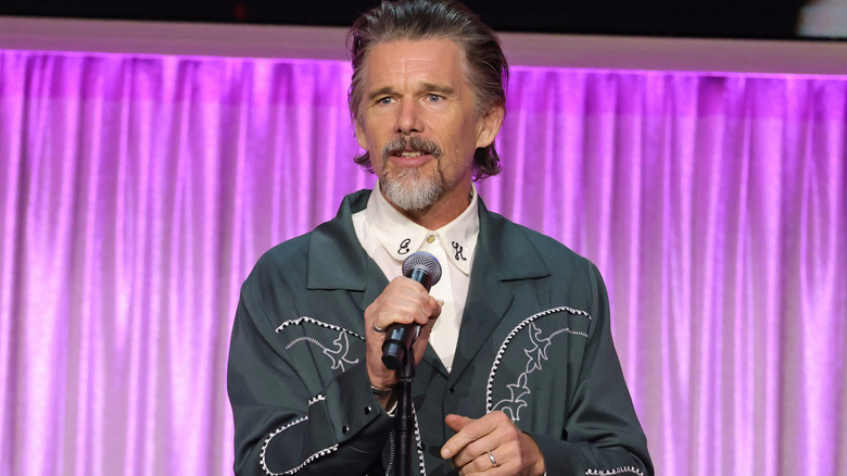 Ethan Hawke addressing an audience in a western shirt