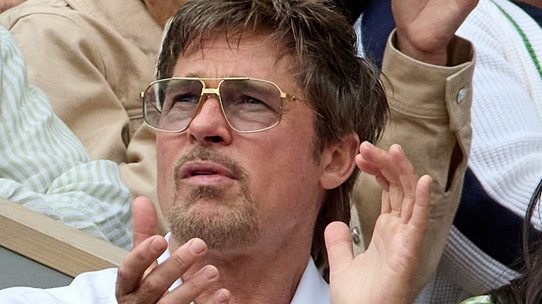 Brad Pitt applauding in sunglasses