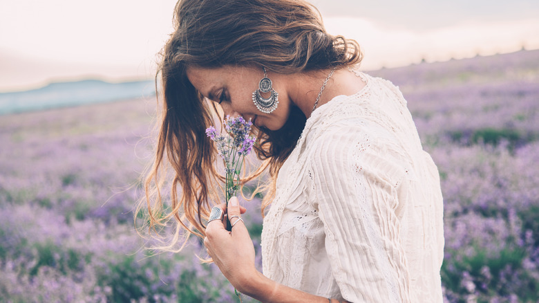 Model walking in a lavender field wearing jewelry