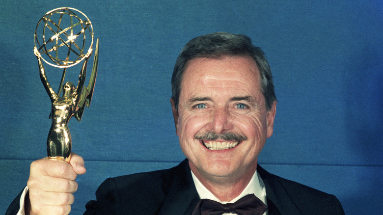 William Daniels smiling and holding Emmy award.