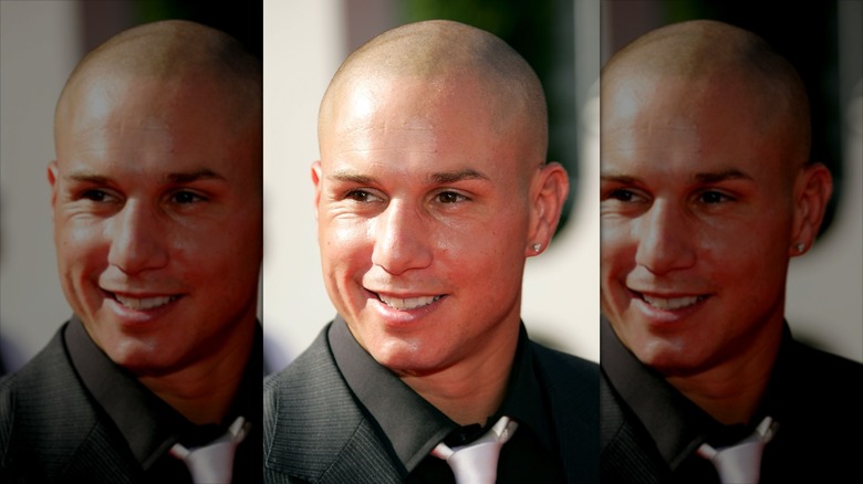 Dave Mirra in a suit and tie with a diamond earring in