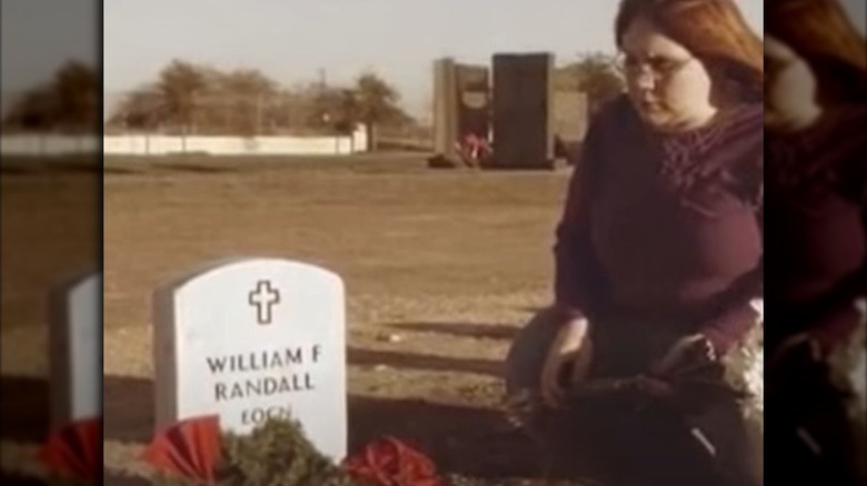 Ashley Randall sitting at a grave