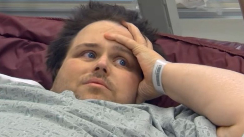 James King with his hand on his face