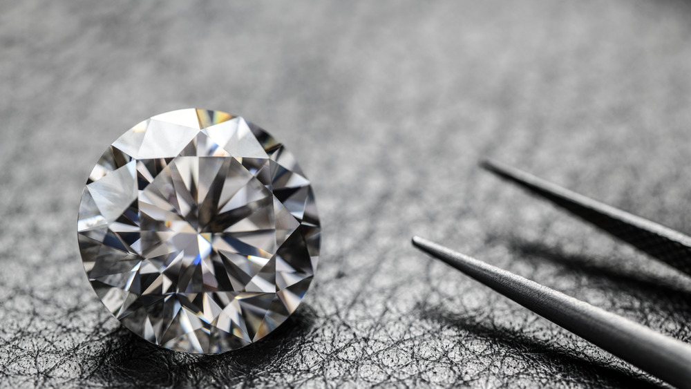 A large diamond and tweezers