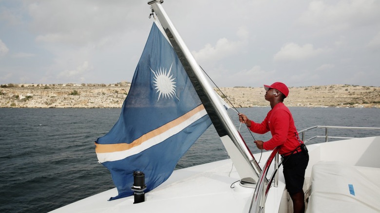 Mzi "Zee" Dempers raising flag on Below Deck