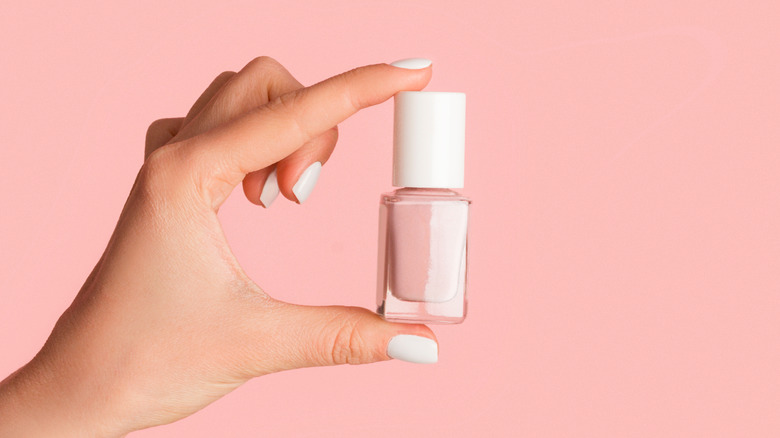 Woman holding pink nail polish