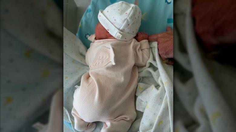An image of Princess Eugenie's newborn daughter wearing a babysuit