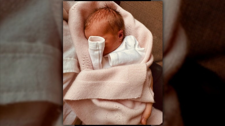 Photo of newborn Athena Elizabeth Rose Mapelli Mozzi covering her face with her arm