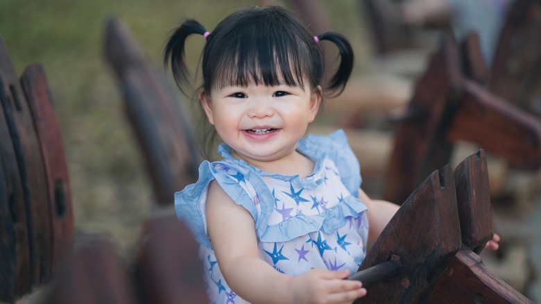 Baby girl on a rocking horse