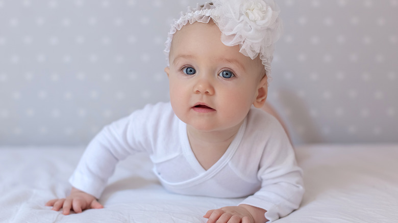 Baby wearing a floral headpiece