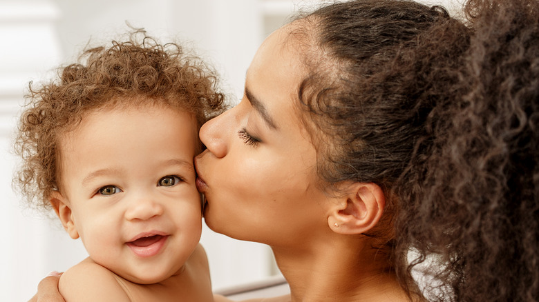 mom kissing baby 