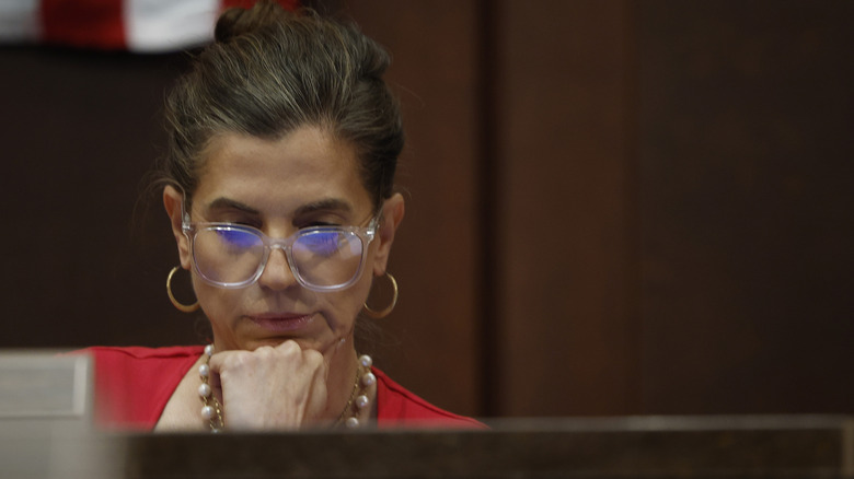 Nancy Mace wearing glasses while reading something with her chin on her hand