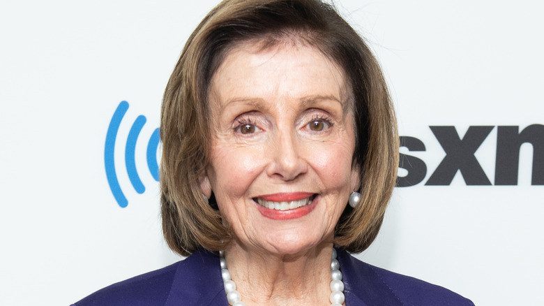 Nancy Pelosi wearing purple suit