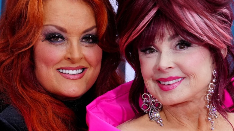 Naomi and Wynonna Judd posing on the pink carpet