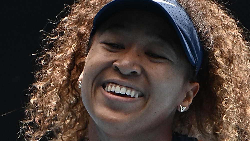 Naomi Osaka smiling on the court