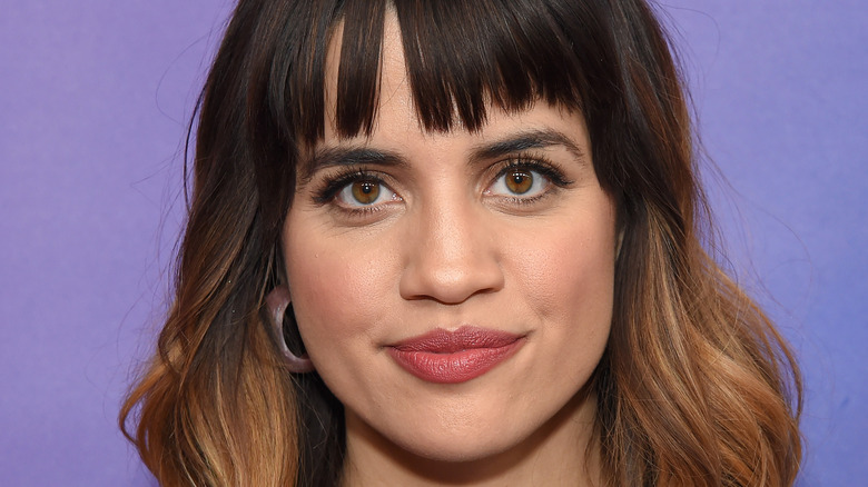 Natalie Morales smiling on the red carpet