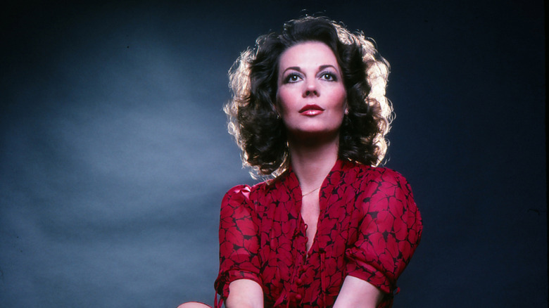 Natalie Wood (in a red dress) posing for a photo in 1979