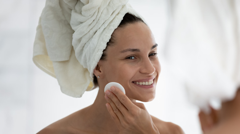 Woman cleaning face