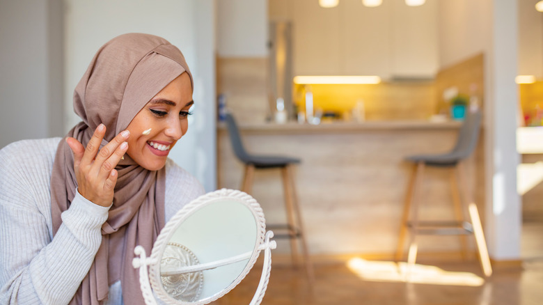 Woman putting skincare on