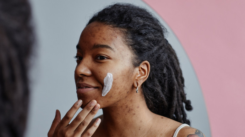woman using cream for scars