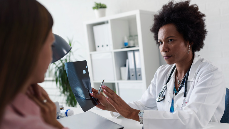 doctor speaks to her patient about a mammogram