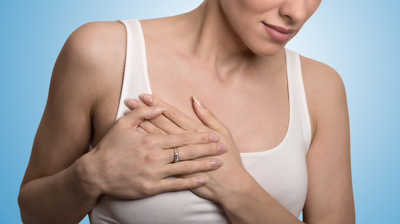 white woman holding breast