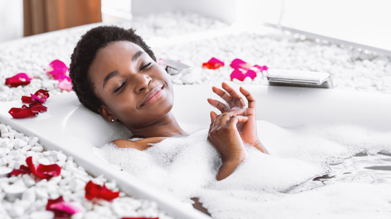 Woman relaxing in bathtub