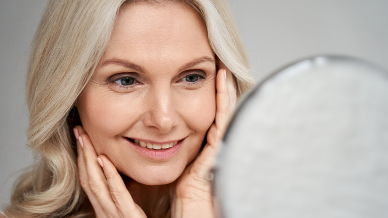 Older woman looking in mirror