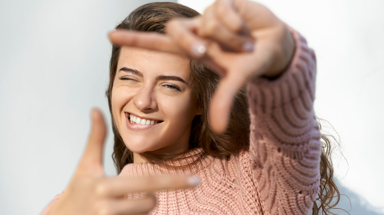 woman framing her face with her fingers