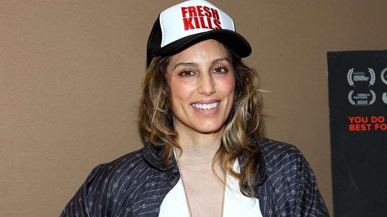Jennifer Esposito smiling and wearing 'Fresh Kills' hat