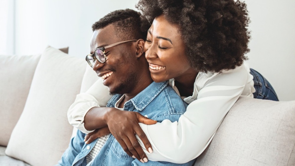 Couple laughing together and hugging