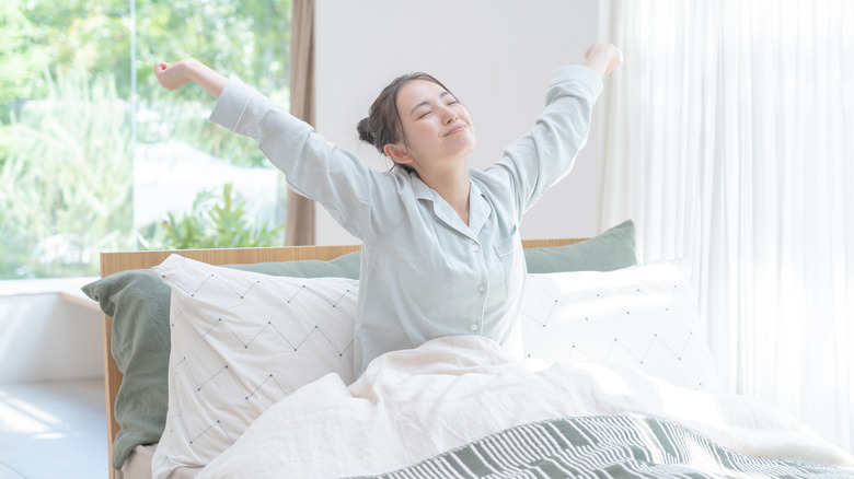 Woman stretching in bed