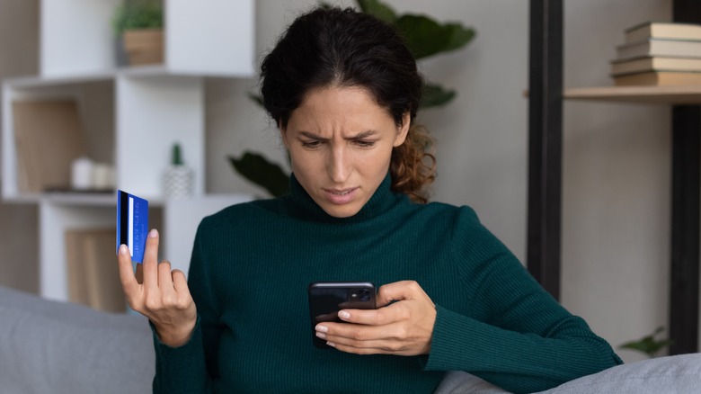 woman holding phone, credit card