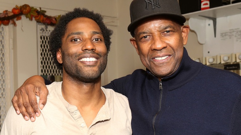Denzel Washington with his arm around his son John David Washington's shoulder