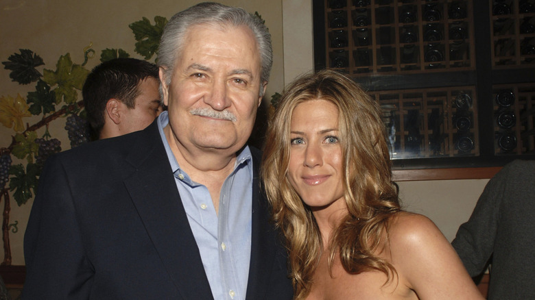 Jennifer Aniston and John Aniston smiling while posing for photos together