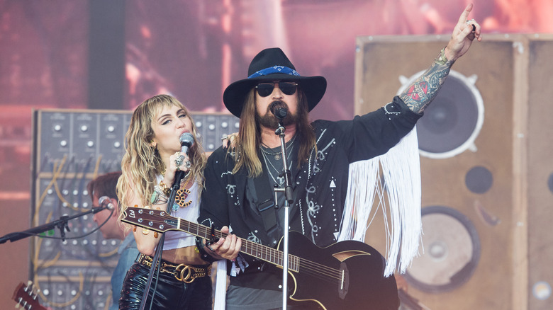 Miley Cyrus and Billy Ray Cyrus performing onstage together