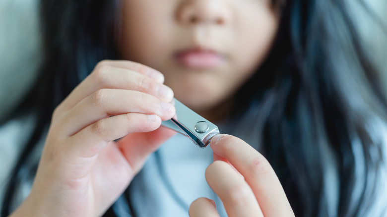 Child clipping her fingernails