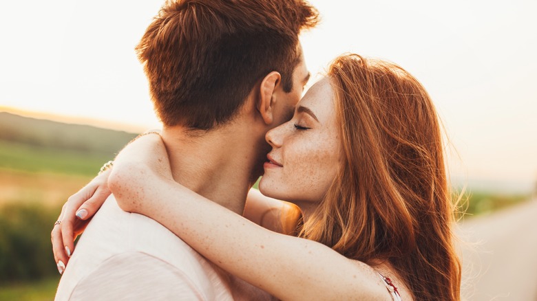 man and woman hugging outside