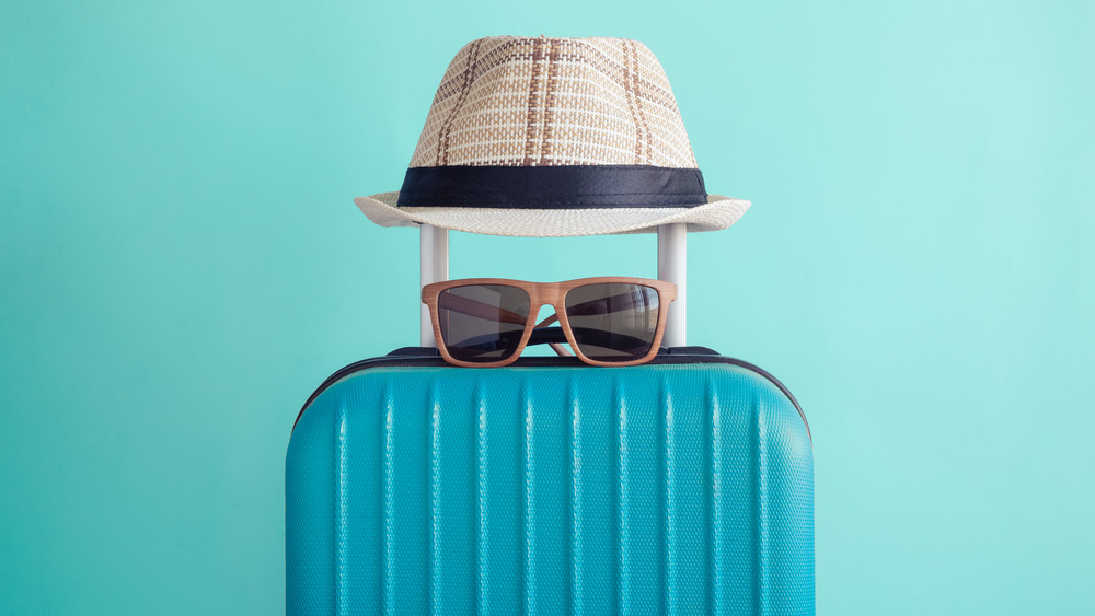 Luggage, sunglasses, and a hat