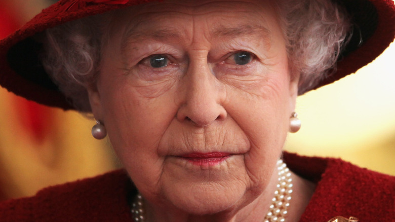 Queen Elizabeth red hat serious