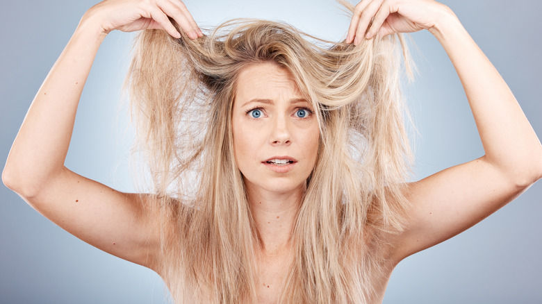 woman holding up hair distressed