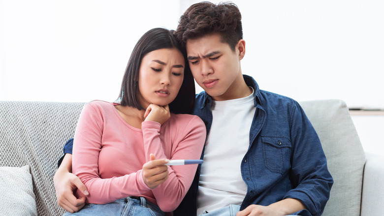 couple looking at pregnancy test