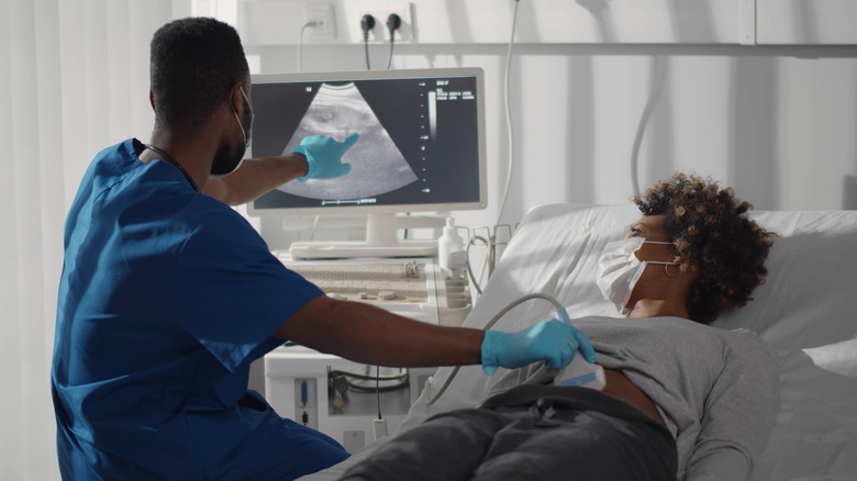 Pregnant woman wearing mask during ultrasound