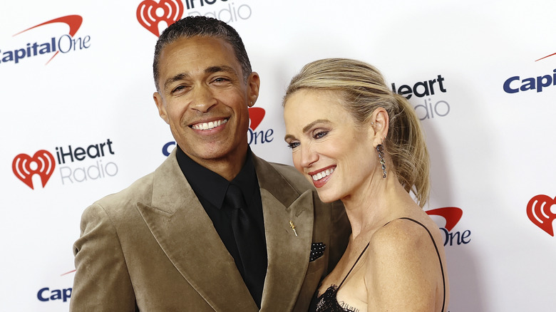 T.J. Holmes and Amy Robach posting at the iHeartRadio Jingle Bell