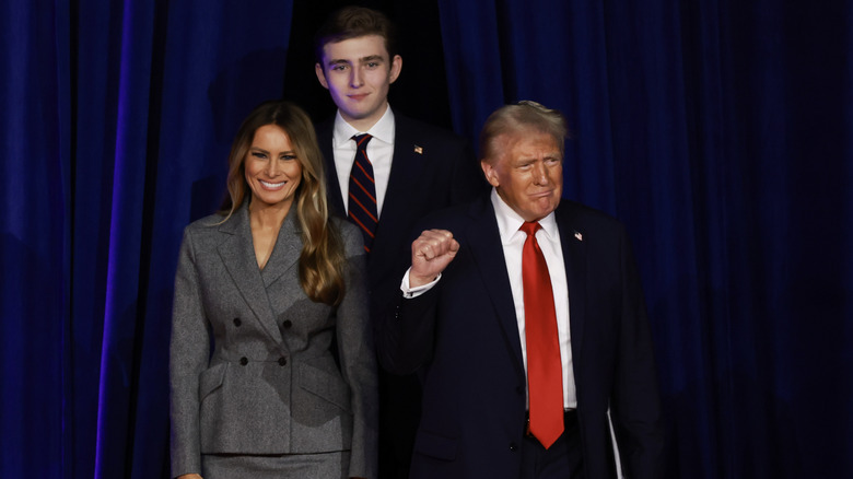 Republican presidential nominee, former U.S. President Donald Trump arrives to speak with former first lady Melania Trump and Barron Trump during an election night event at the Palm Beach Convention Center on November 06, 2024 in West Palm Beach, Florida.