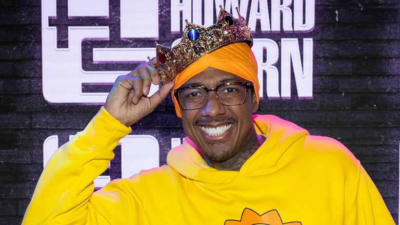 Nick Cannon smiling wearing crown