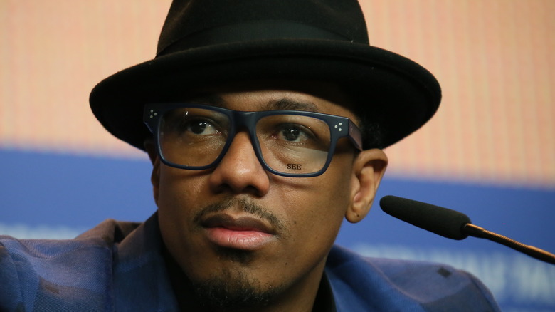 Nick Cannon looks worried in a hat 