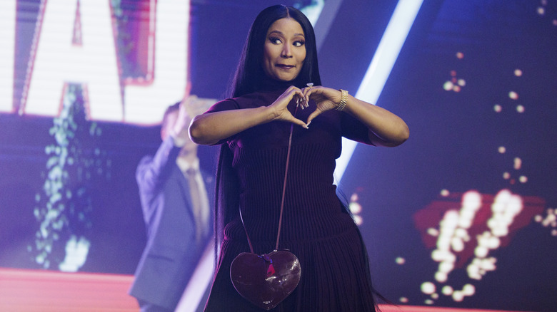 Nicki Minaj giving a heart symbol with her hands