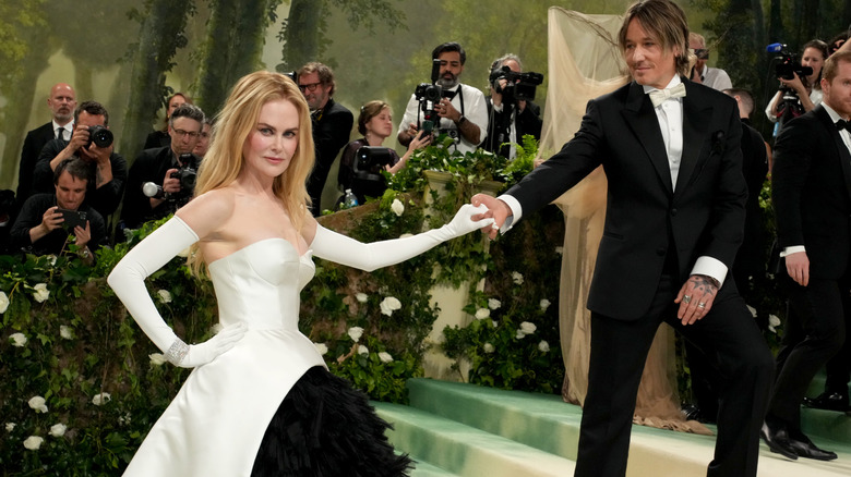 Nicole Kidman and Keith Urban at the MET Gala, standing apart from one another but holding hands.