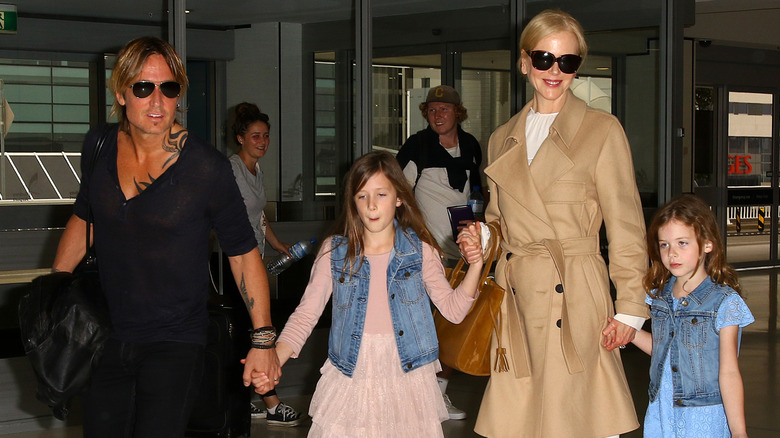 Keith Urban and Nicole Kidman walking with their daughters